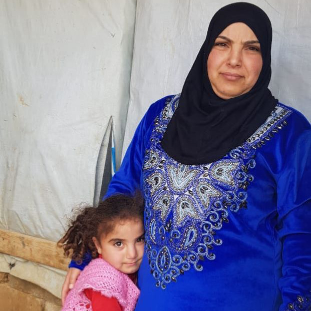Mirna in a refugee camp with her mom