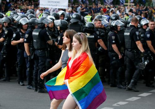 Police officers guard participants of the Equality March, organized by the LGBT community, in Kiev, Ukraine June 23, 2019.  REUTERS/Gleb Garanich - RC1832BC9000