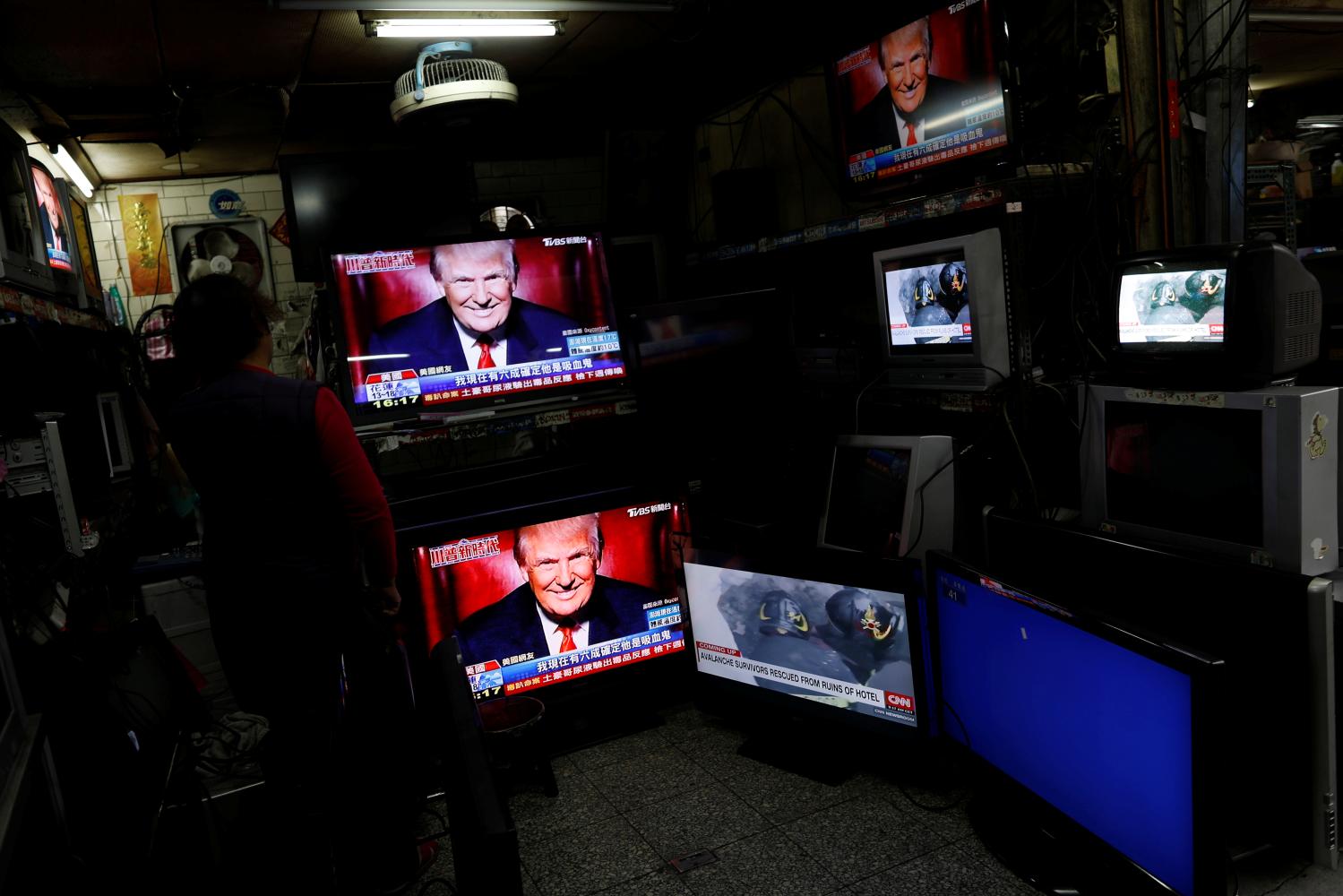 Images of U.S. President Donald Trump are seen on TV screens at a second hand shop in Taipei,Taiwan January 21, 2017. REUTERS/Tyrone Siu - RC1DB4686E10