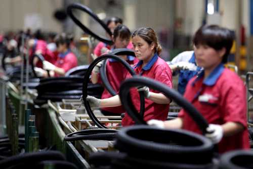 Employees work on the production line of a tyre factory under Tianjin Wanda Tyre Group, which exports its products to countries such as U.S. and Japan, in Xingtai, Hebei province, China May 21, 2019. REUTERS/Jason Lee - RC1B94A641C0
