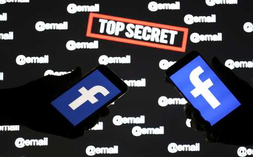 Persons hold smartphones with the Facebook logo in front of displayed "top secret" and "email" words in this picture illustration taken December 6, 2018. REUTERS/Dado Ruvic/Illustration - RC1494681040
