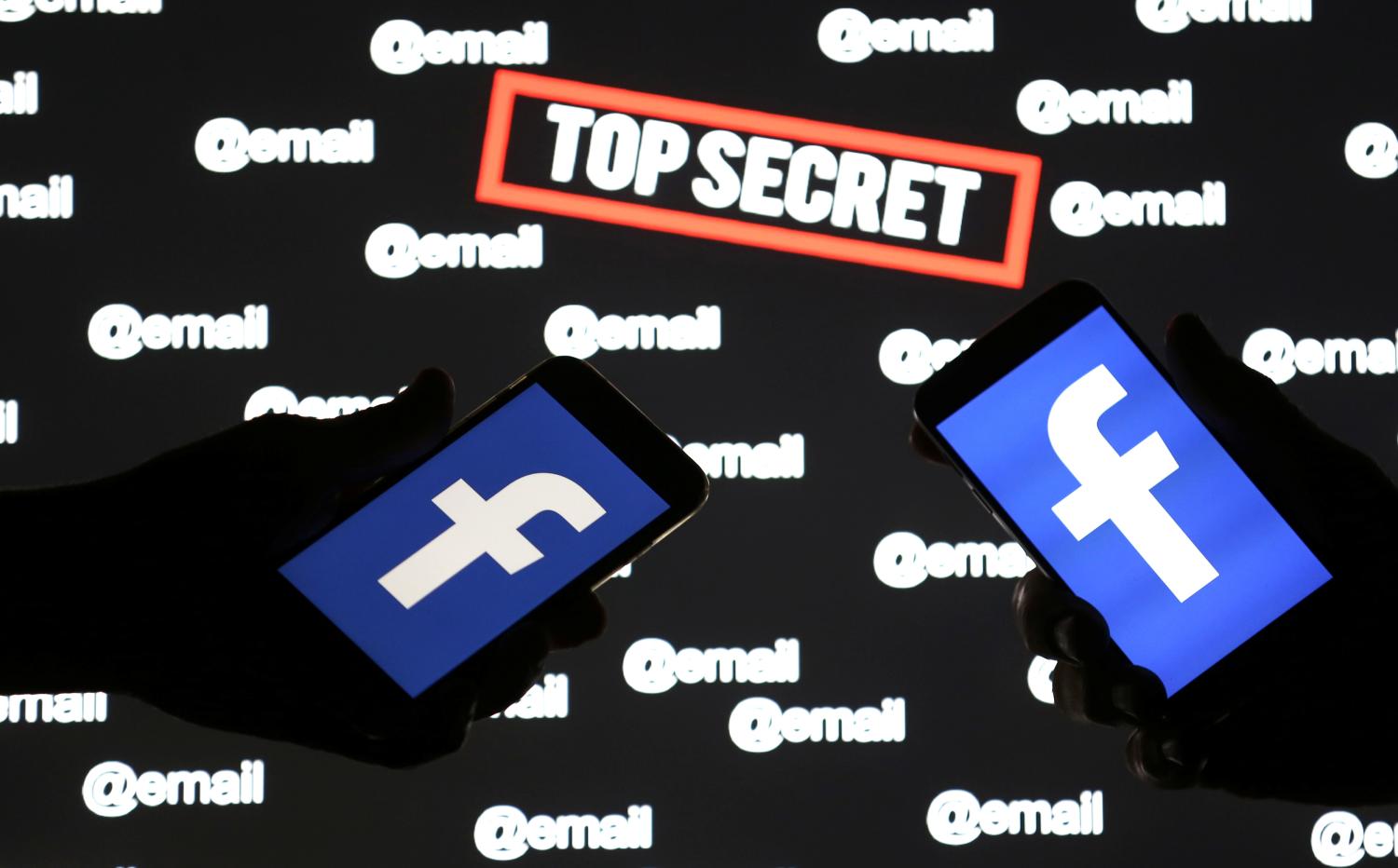Persons hold smartphones with the Facebook logo in front of displayed "top secret" and "email" words in this picture illustration taken December 6, 2018. REUTERS/Dado Ruvic/Illustration - RC1494681040