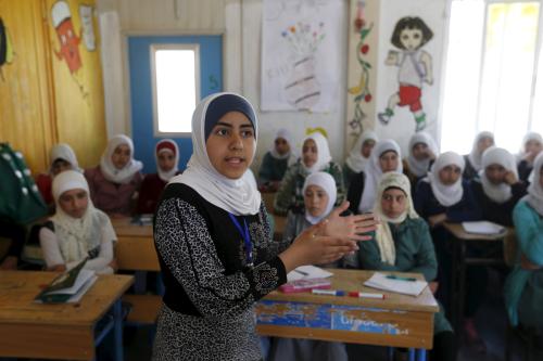 Syrian refugee Omayma al Hushan, 14, who launched an initiative against child marriage among Syrian refugees, speaks to her friends about her initiative at a school in Al Zaatari refugee camp in the Jordanian city of Mafraq, near the border with Syria, April 21, 2016. REUTERS/Muhammad Hamed - GF10000397998