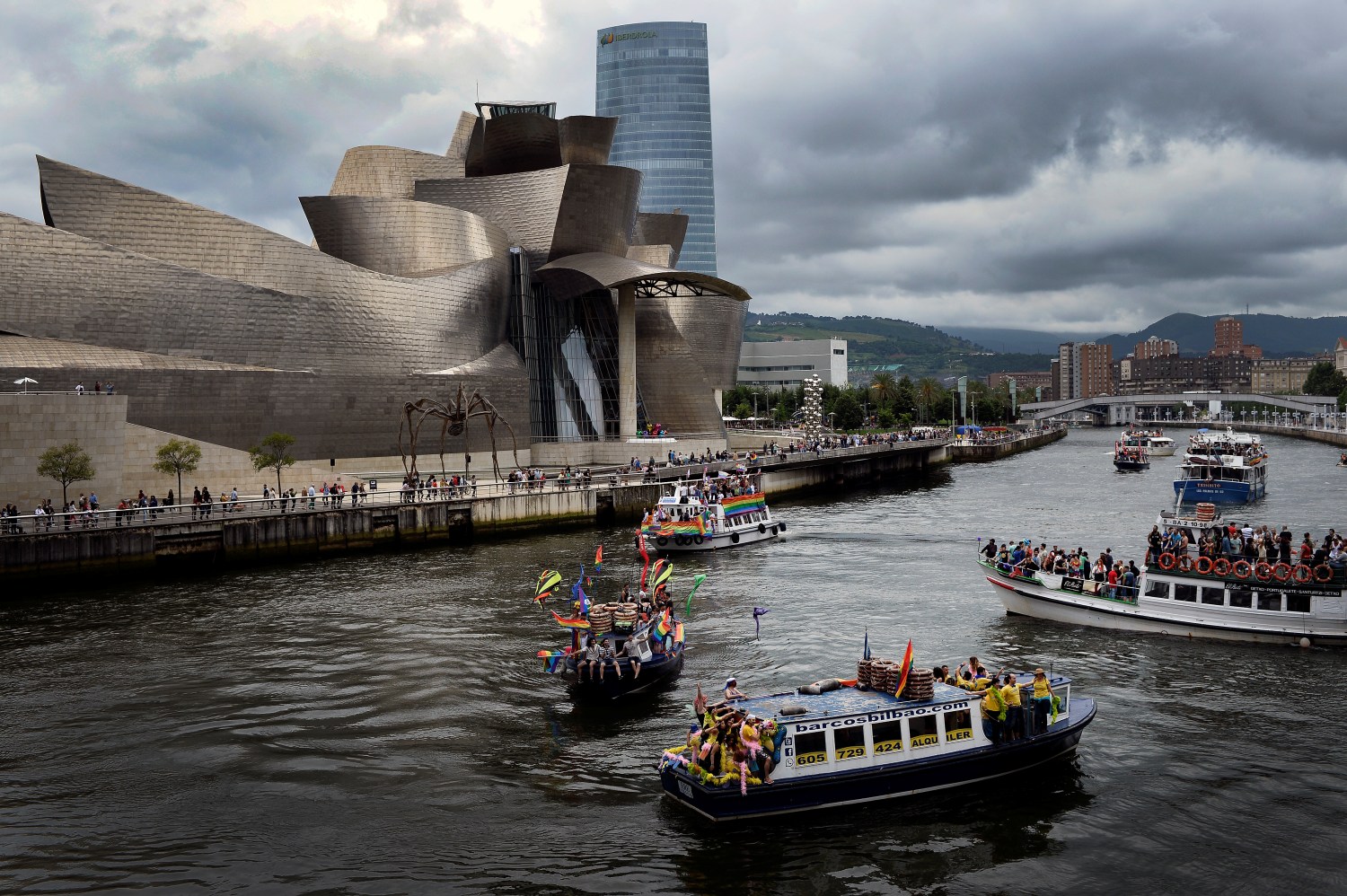 A flotilla of boats takes part in the "Parade For Equality", ahead of WorldPride, an event promoting LGBT issues, on the Nervion River in front of the Guggenheim Museum Bilbao in Bilbao, Spain June 24, 2017. REUTERS/Vincent West - RC1B841435A0