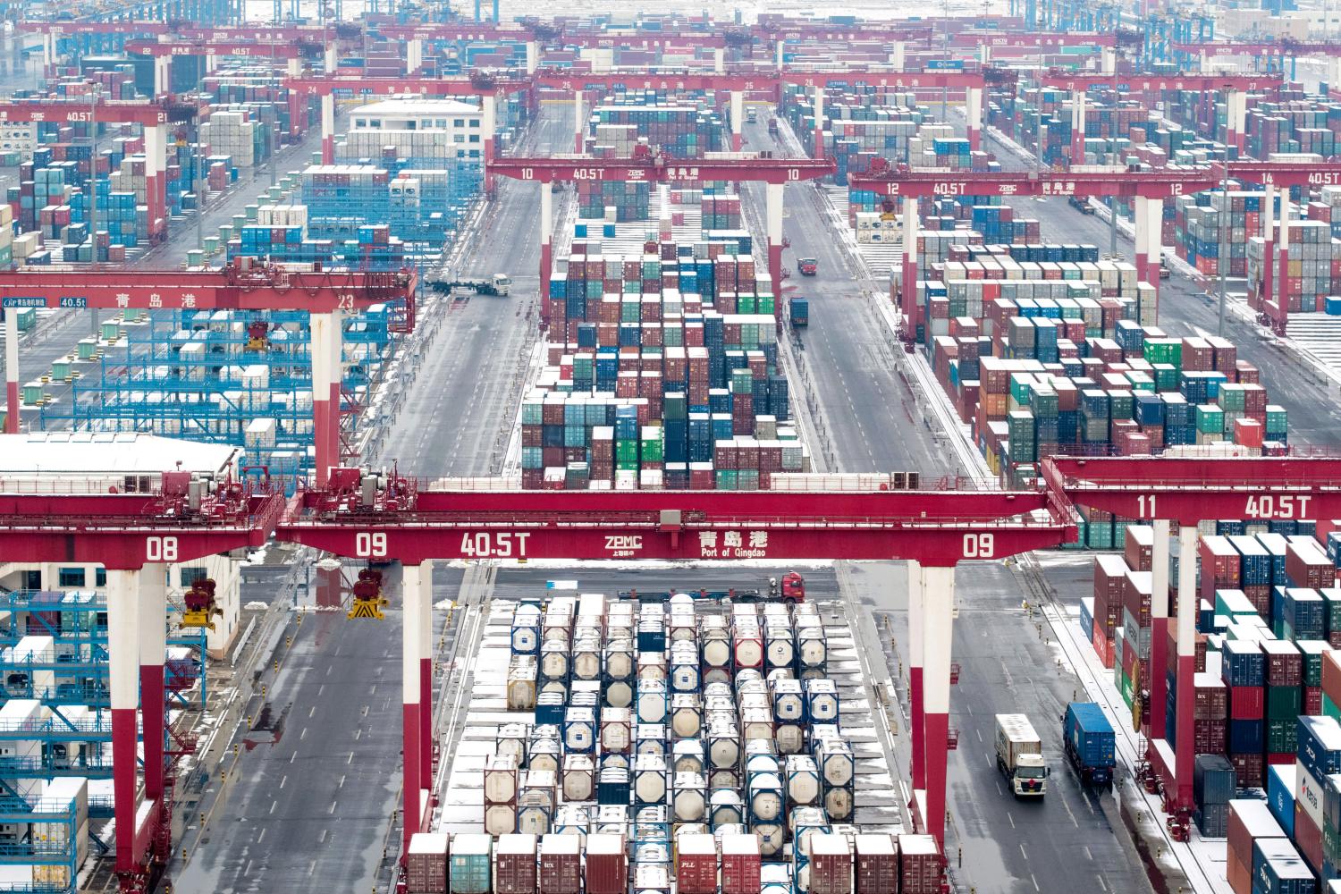 Containers and trucks are seen following a snowfall at the port of Qingdao, Shandong province, China February 14, 2019. REUTERS/Stringer ATTENTION EDITORS - THIS IMAGE WAS PROVIDED BY A THIRD PARTY. CHINA OUT. - RC1AA7D4CB70