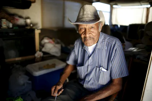 Samuel Cole, 85, poses for a portrait in the motorhome in which he lives on the streets of Los Angeles, California, United States, November 12, 2015. Cole is a retired truck driver who began living in his motorhome two years ago when he couldn't afford the $100 rise in his rent. Los Angeles is grappling with a massive homelessness problem, as forecasted El Nino downpours threaten to add to the misery of thousands of people who sleep on the streets. Mayor Eric Garcetti has proposed spending $100 million to combat the problem in the sprawling metropolis but stopped short of declaring a state of emergency. REUTERS/Lucy Nicholson PICTURE 8 OF 17 - SEARCH "NICHOLSON MOTORHOME" FOR ALL IMAGES   TPX IMAGES OF THE DAY            - GF10000270548