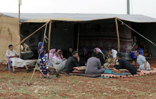 Displaced Syrian refugees sit together during the first day of the Muslim holiday of Eid al-Fitr, in an olive grove at the north of Idlib Countryside, Syria June 4, 2019. Picture taken June 4, 2019. REUTERS/Khalil Ashawi - RC113C40BE00