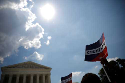 A protester holds a sign outside the U.S. Supreme Court where the court ruled that U.S. President Donald Trump's administration did not give an adequate explanation for its plan to add a citizenship question to the 2020 census, delivering a victory to New York state and others challenging the proposal in Washington, U.S., June 27, 2019. REUTERS/Carlos Barria - RC11B5E74430
