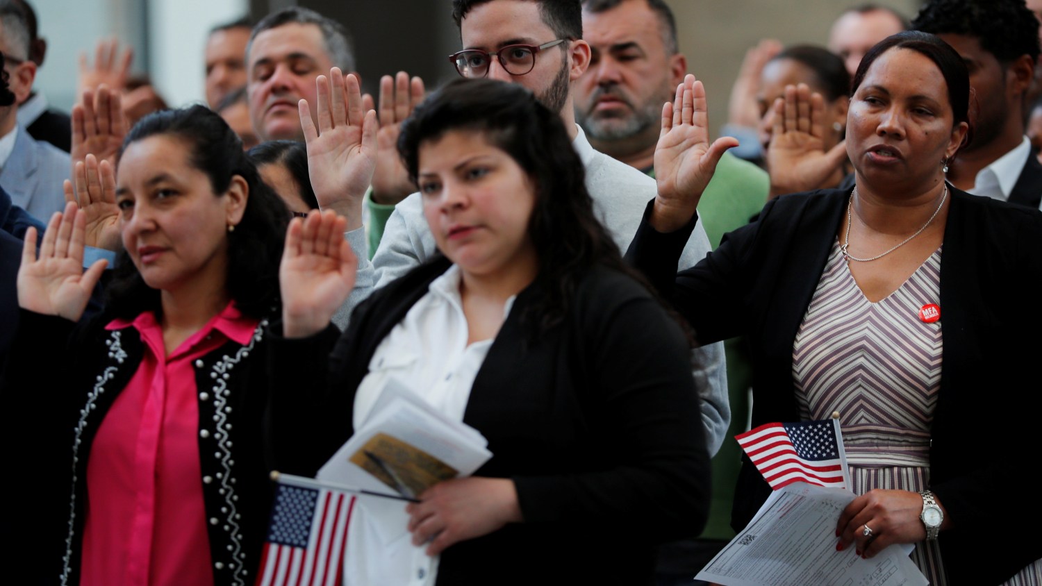 Immigrants take the Oath of Allegiance to become a U.S. citizens during an official Naturalization Ceremony at the Museum of Fine Arts, Boston in Boston, Massachusetts, U.S., May 6, 2019.   REUTERS/Brian Snyder - RC1FAA5D2010