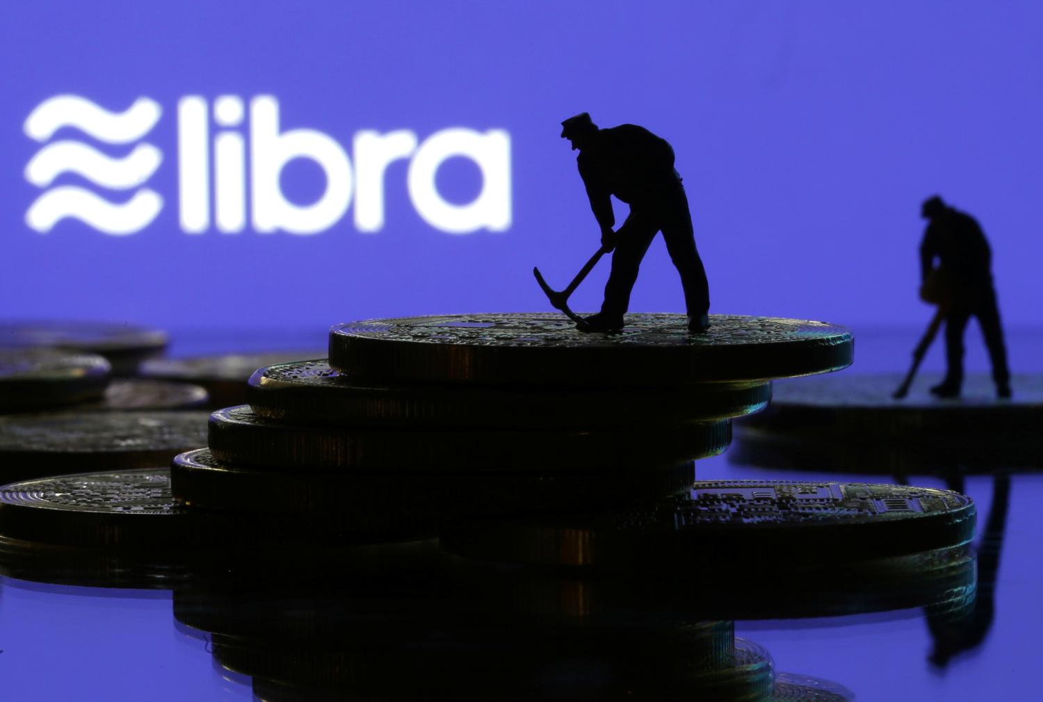 Small toy figures are seen on representations of virtual currency in front of the Libra logo in this illustration picture, June 21, 2019. REUTERS/Dado Ruvic/Illustration - RC11B30C87B0