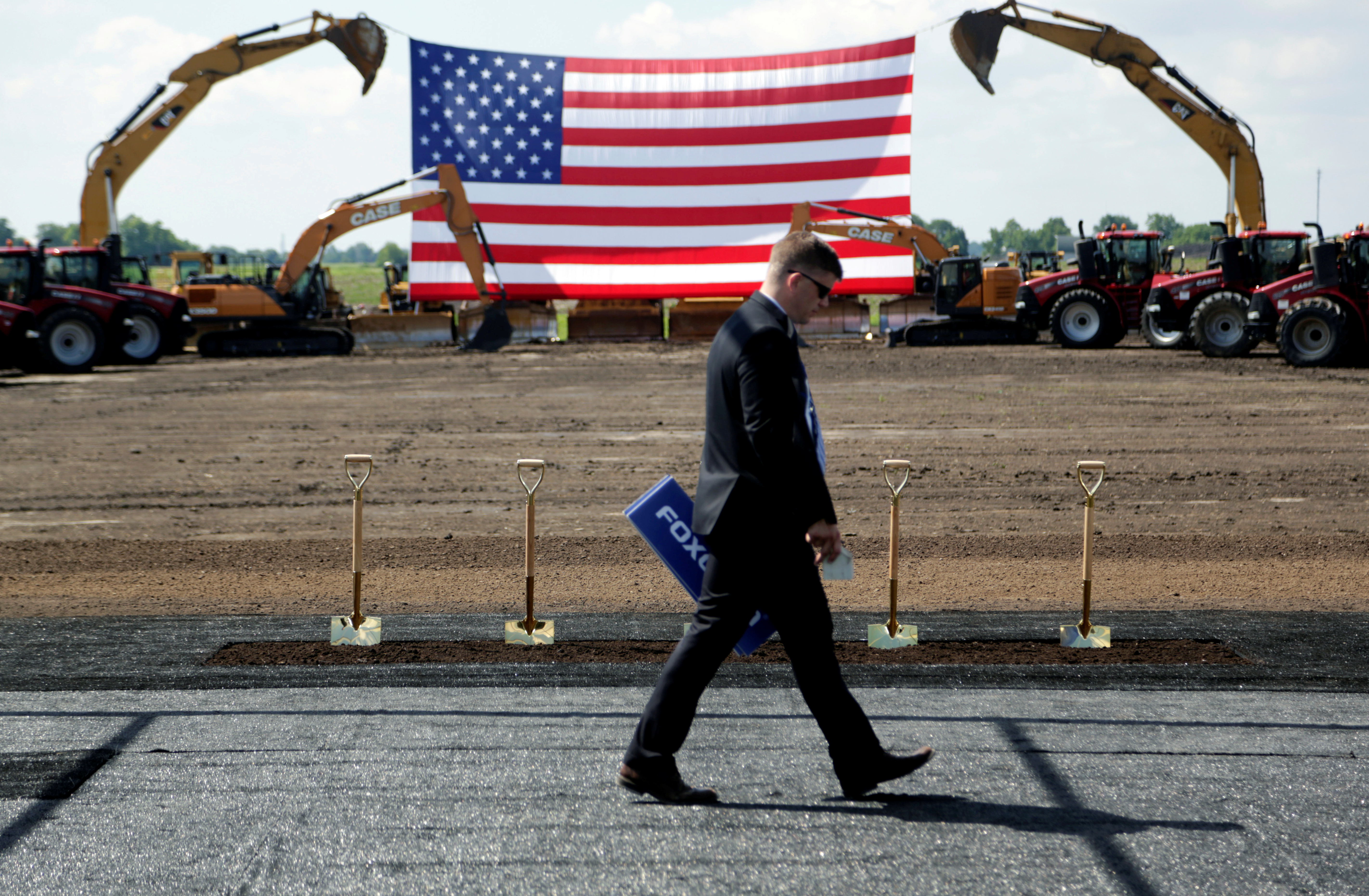 Heavy machinery and the American flag are seen before the arrival of U.S. President Donald Trump as he participates in the Foxconn Technology Group groundbreaking ceremony for its LCD manufacturing campus, in Mount Pleasant, Wisconsin, U.S., June 28, 2018.  REUTERS/Darren Hauck     TPX IMAGES OF THE DAY - RC175D6CD2E0
