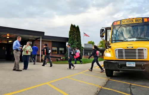Students arrive for class at Mahnomen Elementary School in Mahnomen, Minnesota September 26, 2013. The U.S. government may have headed off some of the most dire predictions about the "sequester," but over seven months, the across-the-board spending cut has thrown sand into the gears of the economic recovery. Mahnomen school district, which serves the White Earth Indian reservation in Minnesota, lost three percent of its funding due to the sequester. The district didn't replace a teacher who retired and has scaled back on homework tutoring and an alternative-school program for teenage mothers. Another year of cuts could force the school to lay off teachers and scale back bus service, superintendent Jeff Bisek says.  Picture taken September 26, 2013. To match Insight USA-BUDGET/SEQUESTER    REUTERS/Dan Koeck   (UNITED STATES - Tags: EDUCATION POLITICS BUSINESS) - GM1E99S159R01