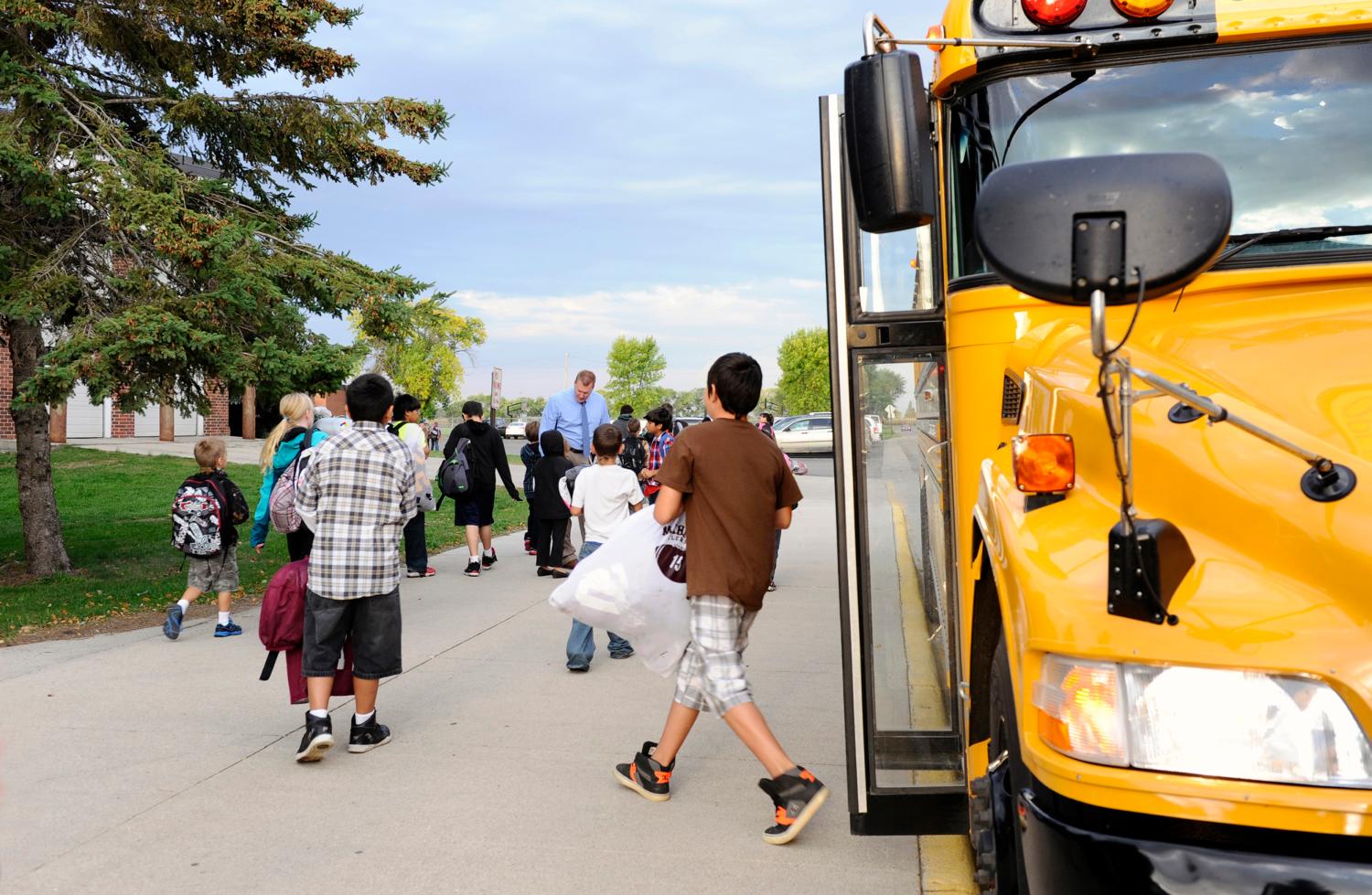 Students arrive for class at Mahnomen Elementary School in Mahnomen, Minnesota September 26, 2013. The U.S. government may have headed off some of the most dire predictions about the "sequester," but over seven months, the across-the-board spending cut has thrown sand into the gears of the economic recovery. Mahnomen school district, which serves the White Earth Indian reservation in Minnesota, lost 3 percent of its funding due to the sequester. The district didn't replace a teacher who retired and has scaled back on homework tutoring and an alternative-school program for teenage mothers. Another year of cuts could force the school to lay off teachers and scale back bus service, superintendent Jeff Bisek says. To match Insight USA-BUDGET/SEQUESTER  Picture taken September 26, 2013.   REUTERS/Dan Koeck   (UNITED STATES - Tags: EDUCATION POLITICS BUSINESS) - GM1E99S159X01