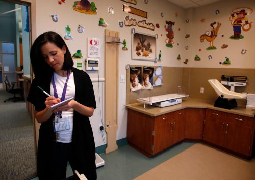 Dietician Krista Mangan prepares an examination room at the Women, Infants and Children (WIC) office inside a Salt Lake County health clinic in South Salt Lake City, Utah, October 2, 2013. The Salt Lake County government appropriated special funding to continue to offer certain aspects of federally funded WIC program for a week while many other WIC offices in Utah have been shut due the federal government shutdown, according to county authorities. REUTERS/Jim Urquhart (UNITED STATES - Tags: POLITICS HEALTH BUSINESS) - GM1E9A30MYF01