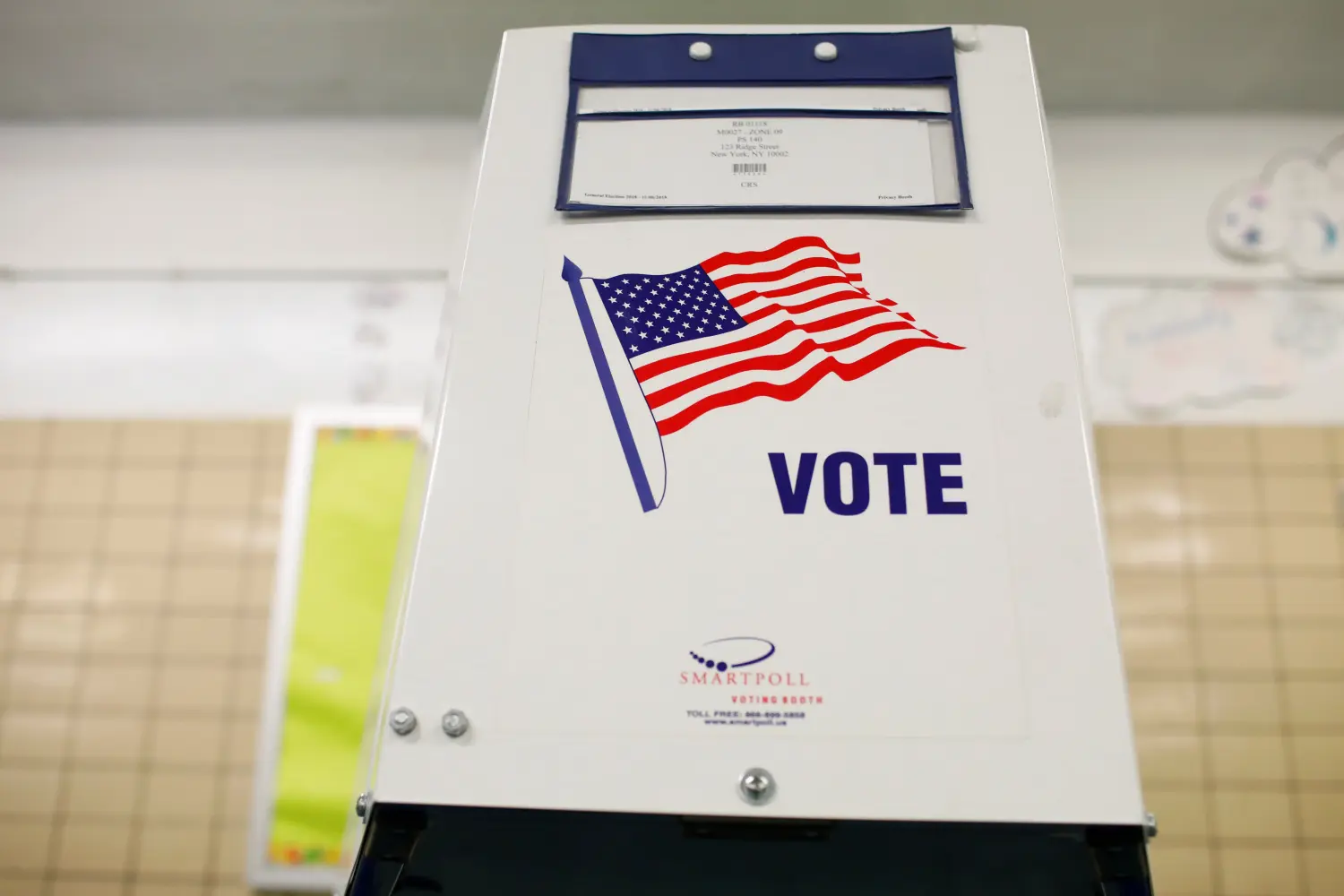 A voting booth is seen as voting opens for the midterm election at P.S. 140 in Manhattan, New York City, U.S., November 6, 2018. REUTERS/Andrew Kelly - RC134B64D810