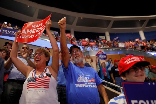 John Lenges, a resident of Pinellas County who changed parties to vote Republican in 2016, and his sister Jeanne Coffin cheer at the conclusion of U.S. President Donald Trumps re-election campaign kick off rally in Orlando, Florida, U.S., June 18, 2019.  Picture taken June 18, 2019.   REUTERS/Brian Snyder - RC1AE0E19DD0