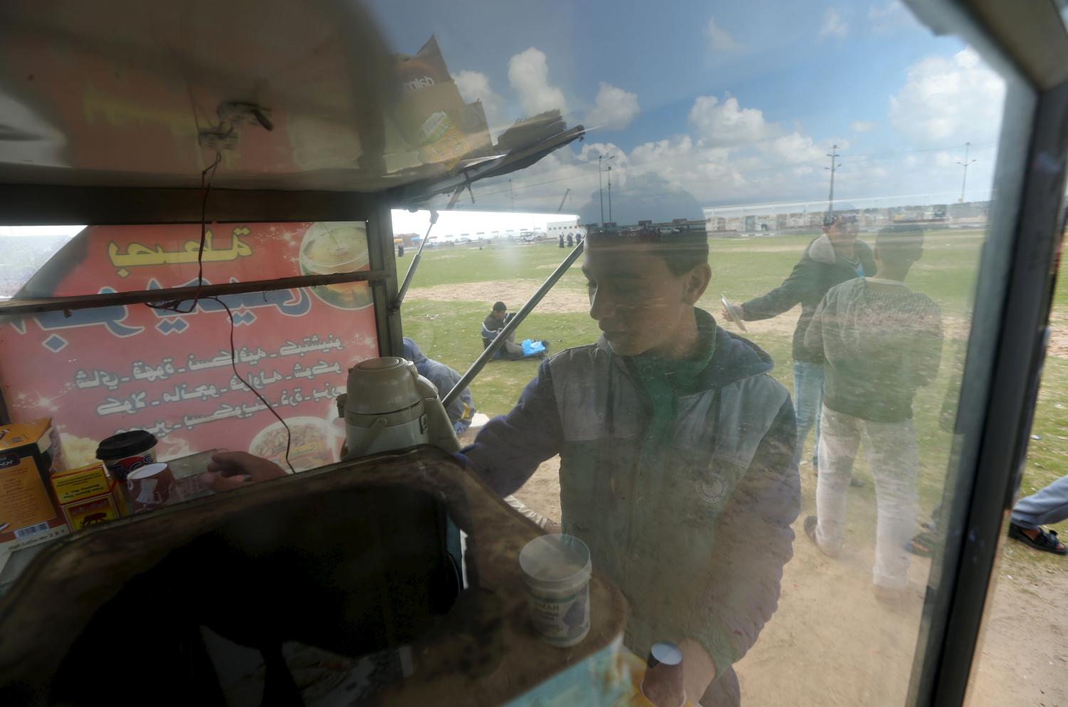 Palestinian boy Ahmed Baker, 16, sells hot drinks on a mobile cart at the Seaport of Gaza City March 17, 2016. Baker, whose father is unemployed, earns around 20 Shekels ($5.1) a day and he is the sole breadwinner of his family. He hoped to be a doctor before quitting school. REUTERS/Mohammed Salem  SEARCH "SALEM LABOUR" FOR THIS STORY. SEARCH "THE WIDER IMAGE" FOR ALL STORIES   - GF10000364375