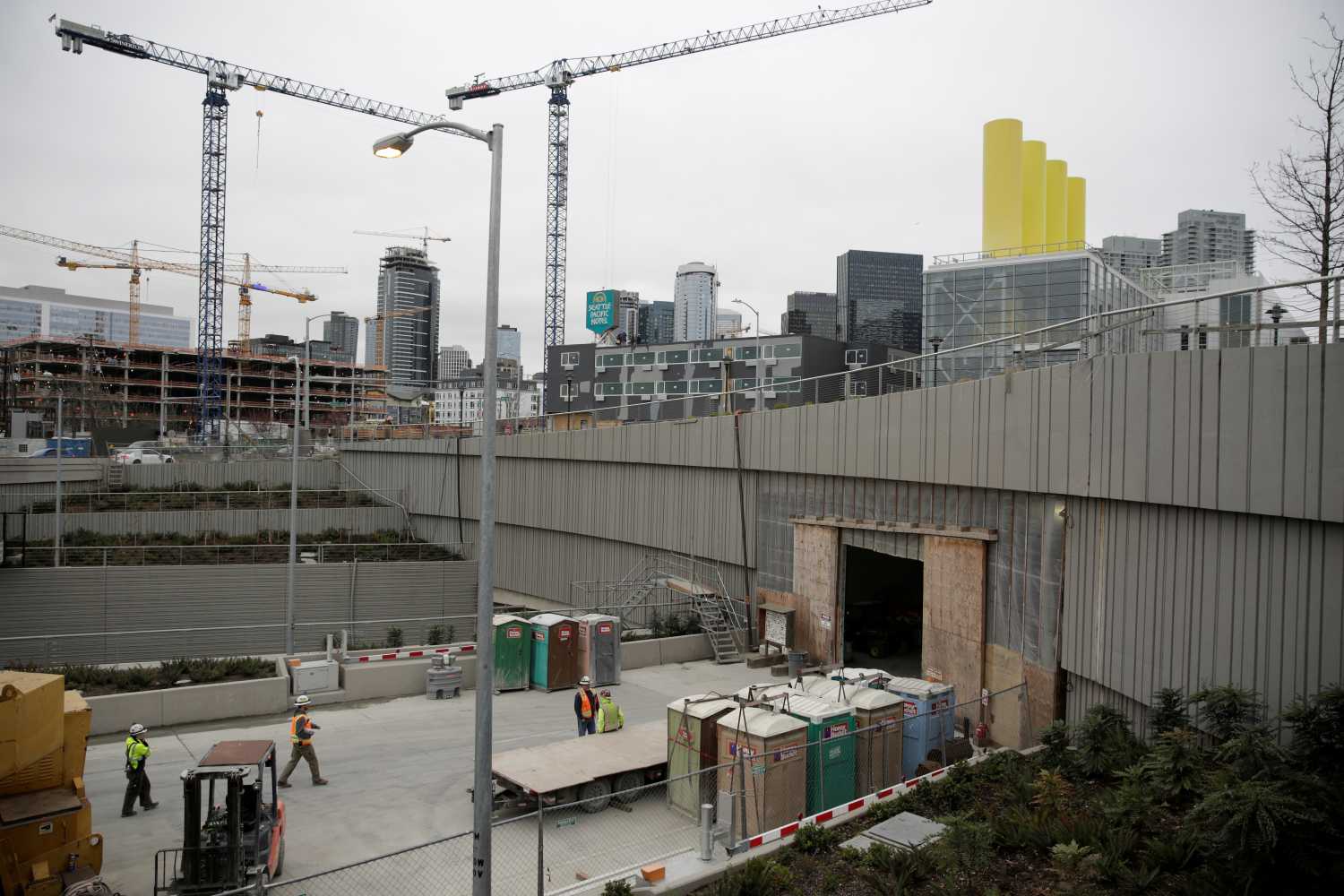Workers are pictured at the southbound entrance to the double deck State Route 99 highway tunnel under construction in Seattle Washington, U.S. March 27, 2018. REUTERS/Jason Redmond - RC176B0BAF20