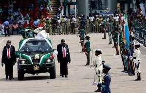 Nigeria's President Muhammadu Buhari bows before the flags of the various military formations during his inspection of the a celebration marking the new Democracy Day, a national holiday in honour of late M.K.O Abiola in Abuja, Nigeria June 12, 2019 REUTERS/Afolabi Sotunde - RC1DEE281A60