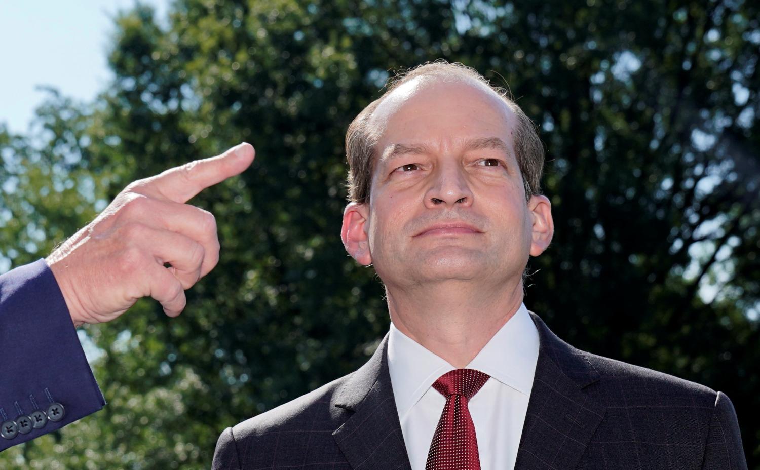 U.S.Labor Secretary Alex Acosta listens as U.S. President Donald Trump announces Acosta's resignation before the president departed for travel to Milwaukee, Wisconsin from the South Lawn of the White House in Washington, U.S., July 12, 2019. REUTERS/Kevin Lamarque?? - RC11300D1CC0
