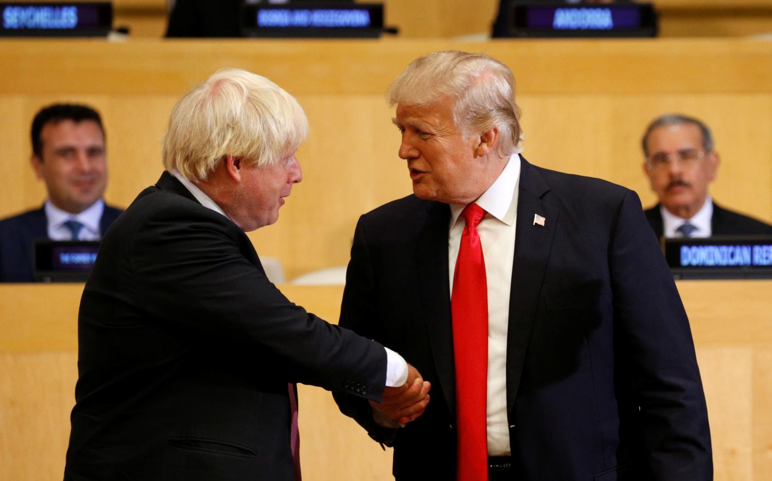 U.S. President Donald Trump shakes hands with British Foreign Secretary Boris Johnson (L) as they take part in a session on reforming the United Nations at U.N. Headquarters in New York, U.S., September 18, 2017. REUTERS/Kevin Lamarque - RC1B969FCF70