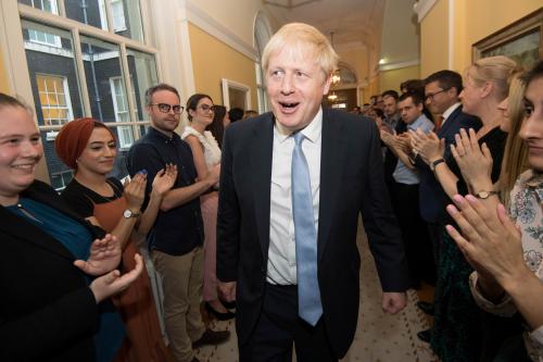 Britain's Prime Minister Boris Johnson is welcomed in 10 Downing Street by staff after meeting Britain's Queen Elizabeth II and accepting her invitation to become Prime Minister and form a new government, in London, Britain July 24, 2019. Stefan Rousseau/Pool via REUTERS - RC19F00AF380