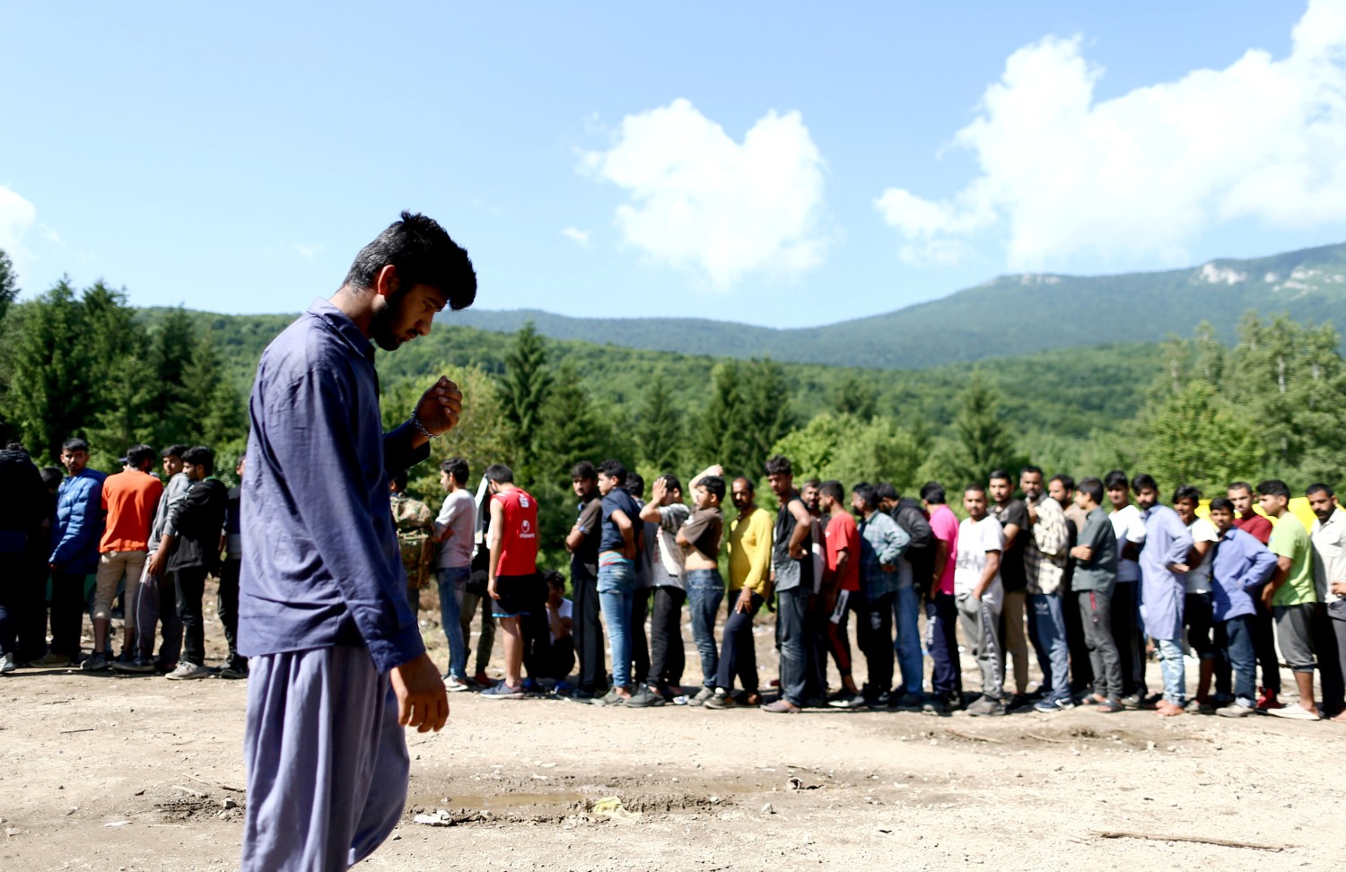 REFILE - CORRECTING GRAMMAR Migrants wait for food and clothes at the migrant camp Vucjak, in Bihac area, Bosnia and Herzegovina, June 19, 2019. REUTERS/Antonio Bronic - RC13263A9760