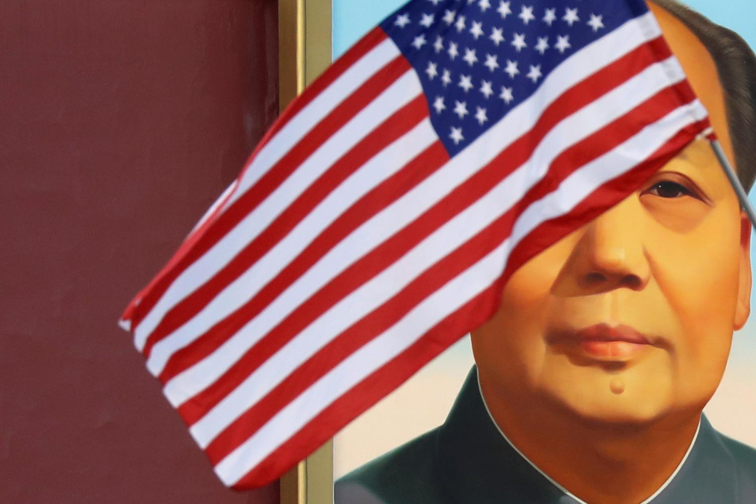 A U.S. flag flutters in front of a portrait of the late Chinese Chairman Mao Zedong at Tiananmen gate during the visit by U.S. President Donald Trump to Beijing, China, November 8, 2017. REUTERS/Damir Sagolj - RC1564EC0810