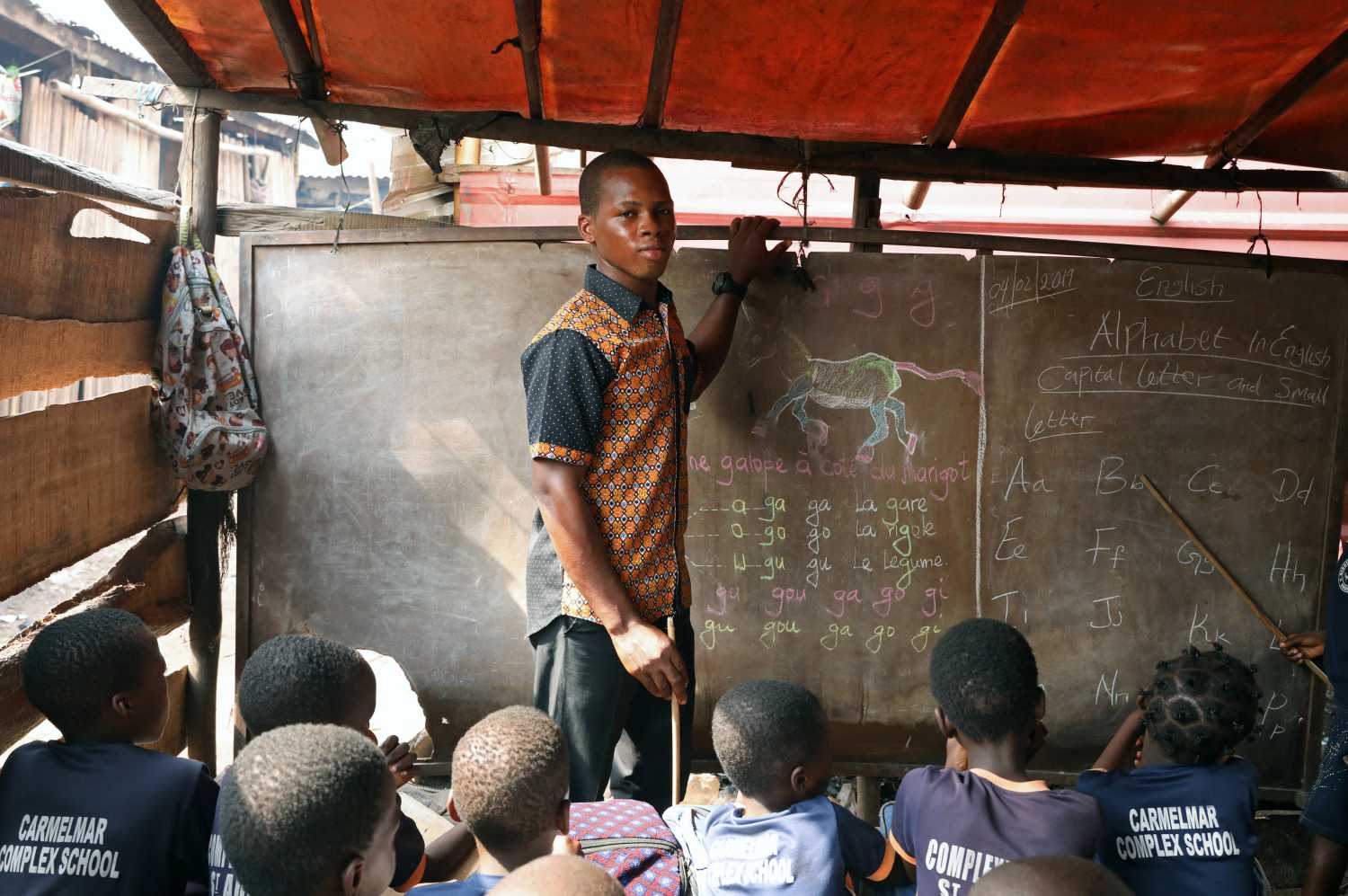 Azonmayon Moses, 21-year-old teacher and first time voter, poses for a picture in his classroom in the Makoko shanty town built on stilts in a lagoon in Lagos, Nigeria February 4, 2019. He is anxious that who ever becomes president does not order the demolition of the precarious settlement he calls home. Azonmayon said: "He must give us assurance that if we vote for them, that they are not going to do anything to us, they must allow us to stay here safely." But he is no fan of the current president. "Everything is hard in the time of Buhari. To find a job is very difficult, to buy food is very hard for us now so that's why we don't need him now." Picture taken February 4, 2019. REUTERS/Temilade Adelaja - RC19D2735C00