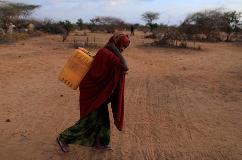 An internally displaced woman from drought hit area carries a jerrycan of water as she walks towards her shelter at a makeshift settlement area in Dollow, Somalia April 4, 2017. REUTERS/Zohra Bensemra - RC13A0B69130