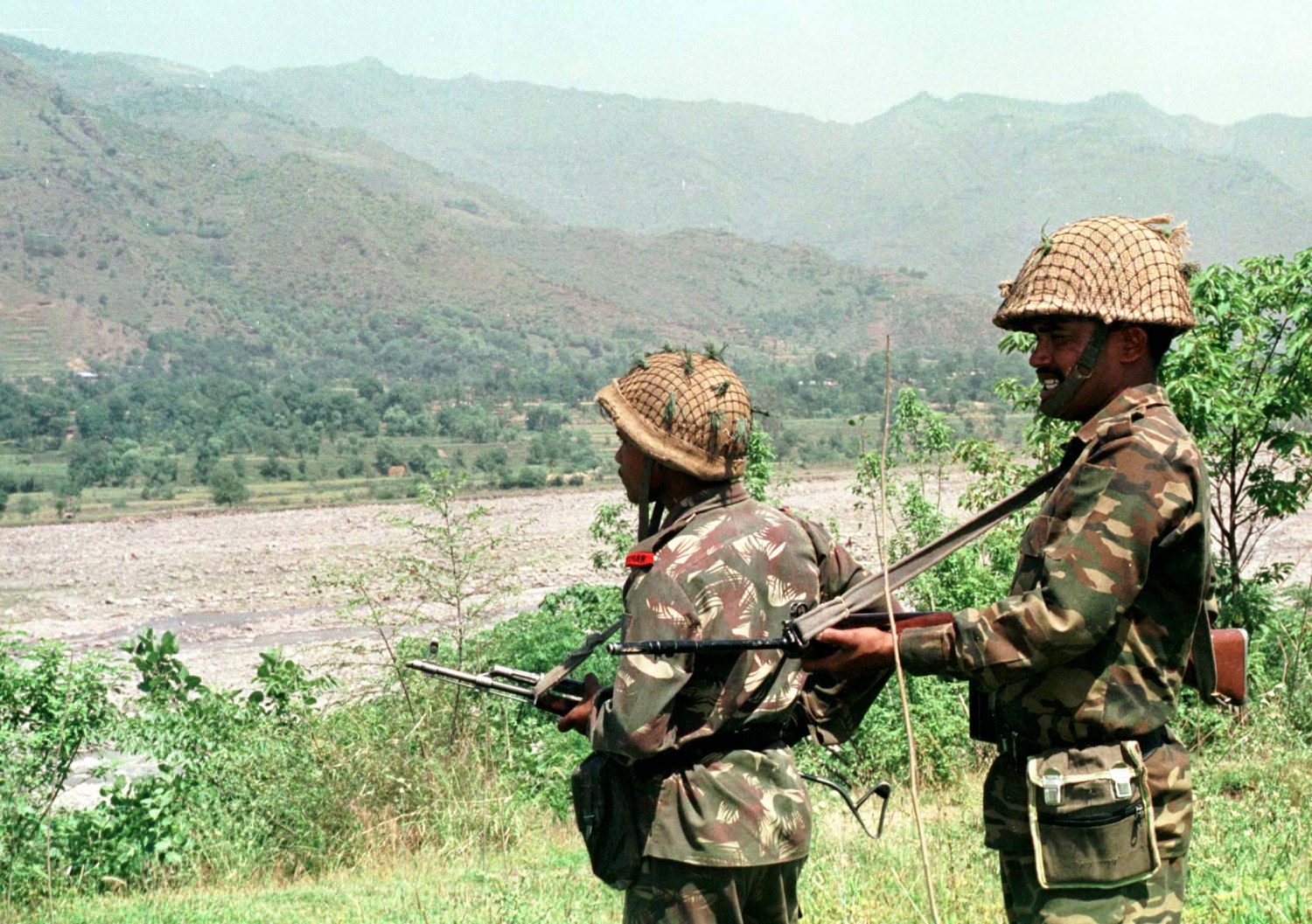 FILE PHOTO 7MAY96 - Indian soldiers keep vigil at Degwar in strife-torn Kashmir which borders Pakistan in this file photo. India on Wednesday launched air strikes on its side of a ceasefire line to expel Pakistan-backed militants who infiltrated in Kashmir's Kargil sector. It also warned Pakistan's army and airforce not to interfere.KK/CC - RP1DRIIGLPAA