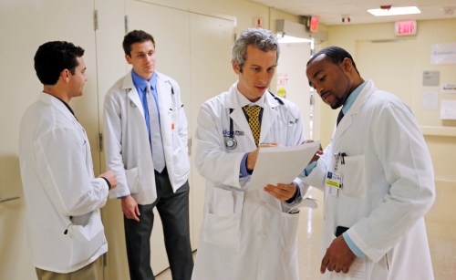 Doctors Jordan Klein (2nd R) and Chane Price (R) confer as University of Miami interns Ignatios Papas (L) and Tim Sterrenberg (2nd L) look on in the Rehabilitation Unit of Jackson Memorial Hospital in Miami, September 30, 2013. The Obama administration accelerated its push to persuade individual Americans to sign up for the most extensive overhaul of the U.S. healthcare system in 50 years, the Affordable Care Act (commonly referred to as Obamacare) even as the program's foes in Congress fought to delay its launch with the threat of a federal government shutdown. The Jackson Health System is the largest in Florida and one of the largest in the U.S.  REUTERS/Joe Skipper (UNITED STATES - Tags: HEALTH) - RTR3FGCZ