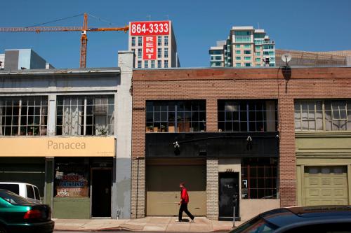 A man walks past warehouse lofts and new apartments in the South of Market area in San Francisco, California May 25, 2012. More than ever, technology entrepreneurs, and their investors and employees, are choosing the urban charms of San Francisco over the sprawl of neighboring Silicon Valley. In the South of Market district, the nexus of the city's tech industry, rents are soaring and latte lines are lengthening - conjuring memories of the dot-com bubble of the late 1990s. Picture taken May 25. To match Feature SANFRANCISCO-SILICONVALLEY/GEEKS      REUTERS/Robert Galbraith (UNITED STATES - Tags: BUSINESS SCIENCE TECHNOLOGY REAL ESTATE) - GM1E86110KI01