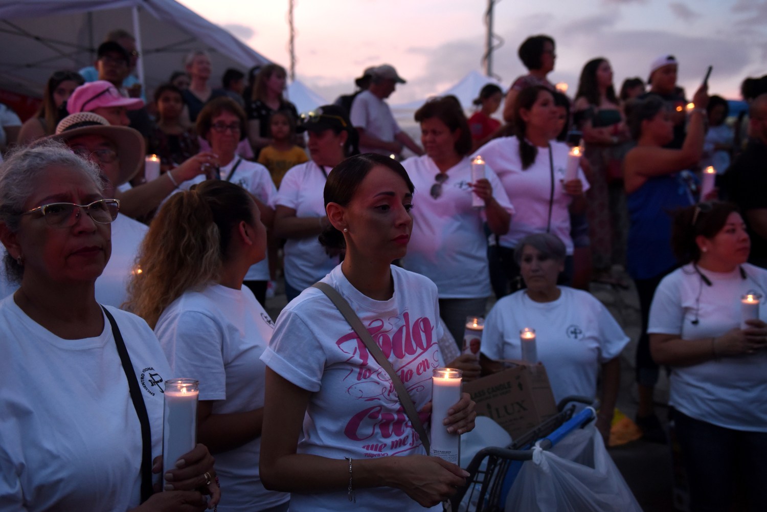 A group of people hold candles during a vigil at a memorial four days after a mass shooting at a Walmart store in El Paso, Texas, U.S. August 7, 2019.  REUTERS/Callaghan O'Hare - RC130E871640