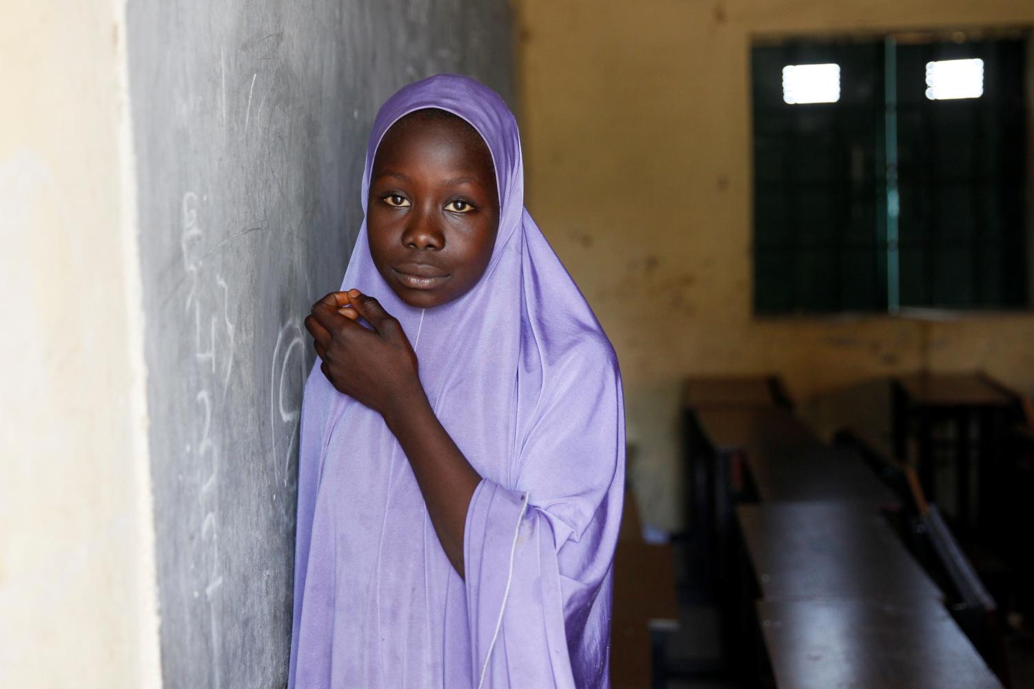 A girl wearing hijab stands in a classroom Hausari primary school  in Michika village, northeast Nigeria June 12, 2017. Picture taken June 12, 2017. REUTERS/Akintunde Akinleye - RC1828EAF0C0