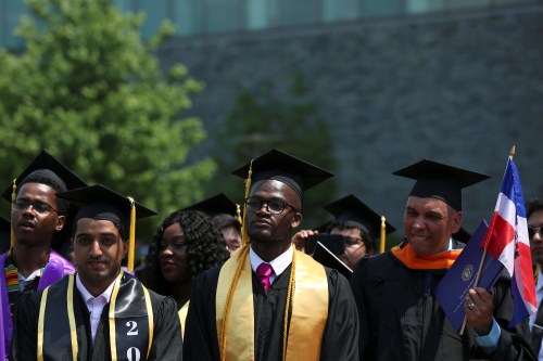 Graduates of The City College of New York stand at their commencement ceremony in Manhattan on May 31, 2019. REUTERS/Gabriela Bhaskar - RC1BEA7E4900