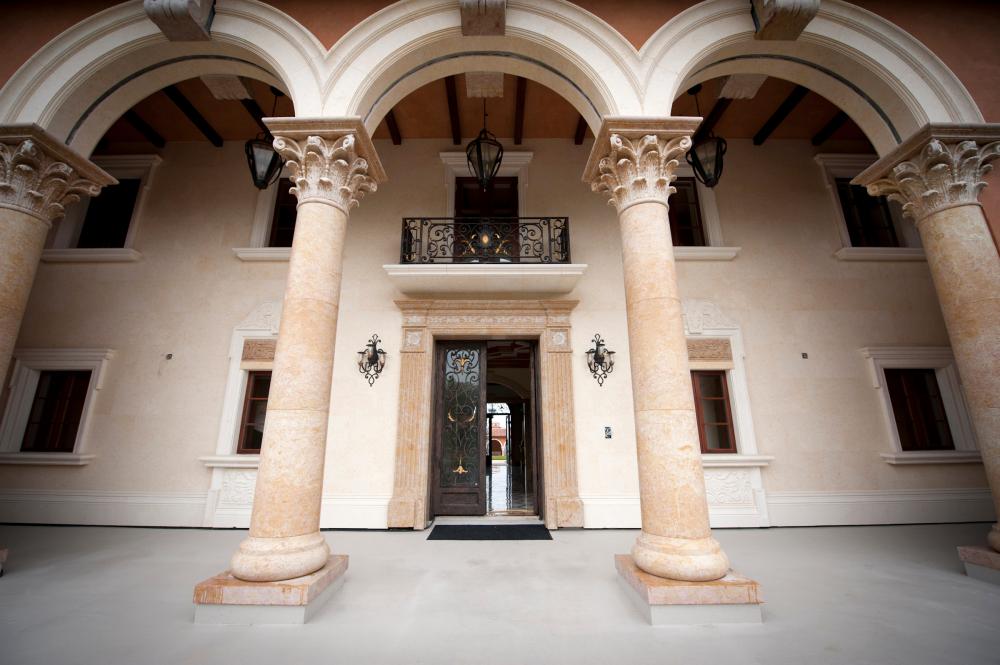 The main entrance of a for sale, $37 million dollar luxury home at One Pelican Hill Road North is seen in Newport Beach, California April 13, 2012. It has 17 bathrooms, a 17-car garage, marbled floors, gold leaf ceilings, a vineyard, horse stables, tennis courts and a lake - and occupies the largest parcel of residential real estate on southern California's exclusive Newport Coast. This empty, never-sold, soon-to-be-auctioned mega-mansion is a gaudy symbol of the runaway extravagance that gripped the top end of the U.S. real estate market before the housing crash of 2008. Once valued at $87 million, it could be sold for a quarter of that price at an auction next week. Picture taken April 13, 2012. REUTERS/Lori Shepler (UNITED STATES  - Tags: BUSINESS REAL ESTATE) - GM1E84I09X002