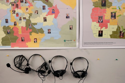 Maps of Georgia, split into house of representatives districts, can be seen with headphones for phone banking at Republican gubernatorial candidate Brian Kemp's campaign office during a phone banking event in Atlanta, Georgia, U.S., November 5, 2018. REUTERS/Leah Millis - RC1CE0096190