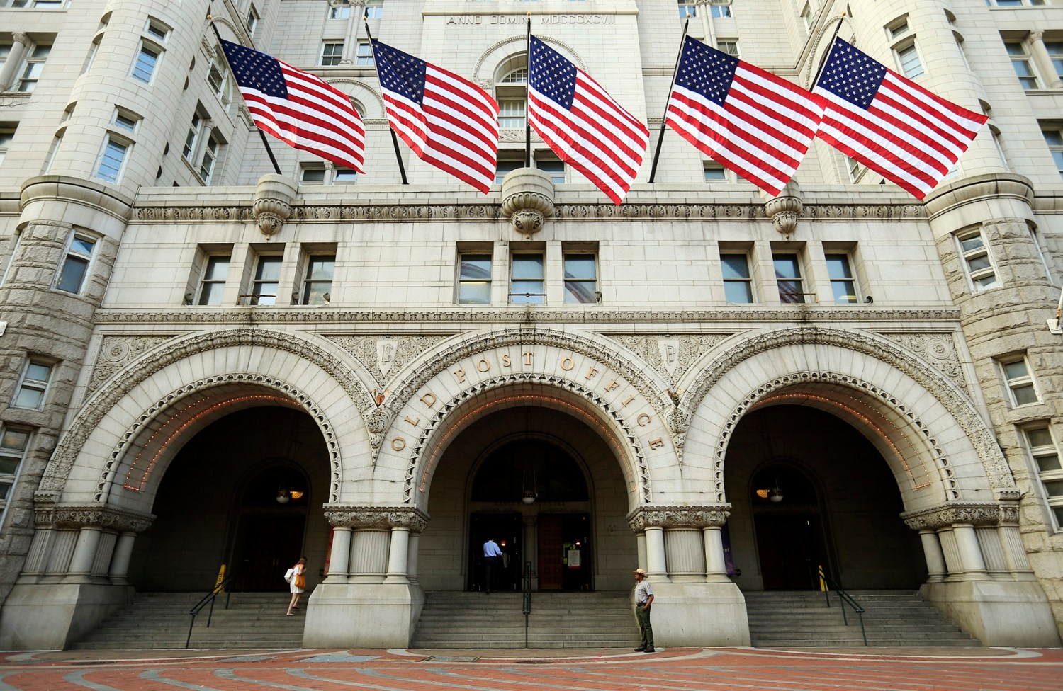 U.S. flags fly on the Old Post Office in Washington September 10, 2013. U.S. real-estate mogul Donald Trump unveiled on Tuesday a $200 million redevelopment plan of the iconic building by the Trump Organization, into a luxury hotel, according to news reports. REUTERS/Kevin Lamarque (UNITED STATES - Tags: BUSINESS SOCIETY WEALTH TRAVEL REAL ESTATE) - GM1E99A1S1O01