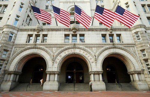 U.S. flags fly on the Old Post Office in Washington September 10, 2013. U.S. real-estate mogul Donald Trump unveiled on Tuesday a $200 million redevelopment plan of the iconic building by the Trump Organization, into a luxury hotel, according to news reports. REUTERS/Kevin Lamarque (UNITED STATES - Tags: BUSINESS SOCIETY WEALTH TRAVEL REAL ESTATE) - GM1E99A1S1O01