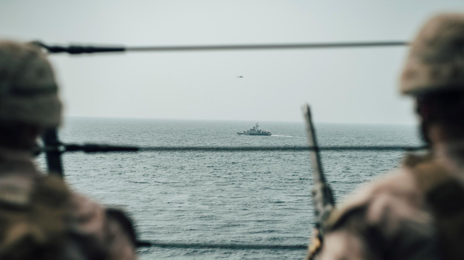 U.S. Marines observe an Iranian fast attack craft from USS John P. Murtha during a Strait of Hormuz transit, Arabian Sea off Oman, in this picture released on July 18, 2019. Donald Holbert/U.S. Navy/Handout via REUTERS ATTENTION EDITORS- THIS IMAGE HAS BEEN SUPPLIED BY A THIRD PARTY. - RC1FF5621490