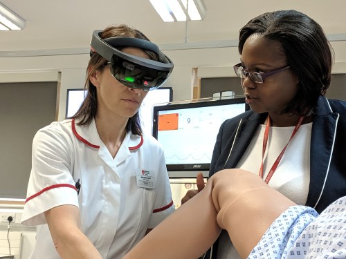 Midwifery educator at Middlesex University Sarah Chitongo instructs a trainee midwife wearing an augmented reality (AR) headset in London, Britain June 17, 2019. Picture taken June 17, 2019. REUTERS/Stuart McDill - RC18635B8A10