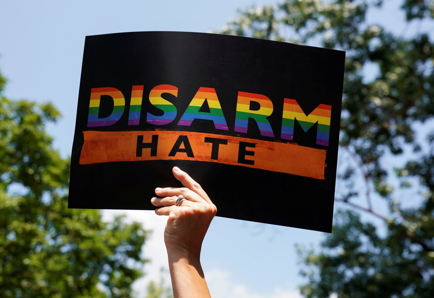 A woman holds a sign during a rally against white supremacy in the wake of mass shootings in Dayton and El Paso in front of the White House in Washington, U.S., August 6, 2019.  REUTERS/Kevin Lamarque - RC18B8E32740