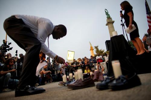 People gather for a vigil to remember victims of the mass shootings at Dayton and El Paso, at Grand Army Plaza in Brooklyn, New York, U.S., August 5, 2019. REUTERS/Eduardo Munoz - RC1946393E00
