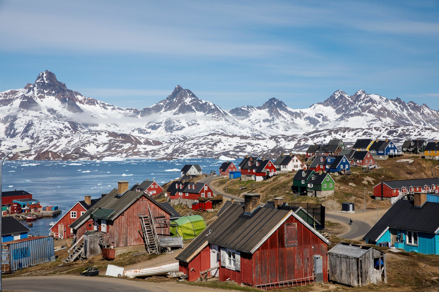 Snow covered mountains rise above the harbour and town of Tasiilaq, Greenland, June 15, 2018. REUTERS/Lucas Jackson  SEARCH "JACKSON TASIILAQ" FOR THIS STORY. SEARCH "WIDER IMAGE" FOR ALL STORIES. - RC1247ABC2C0