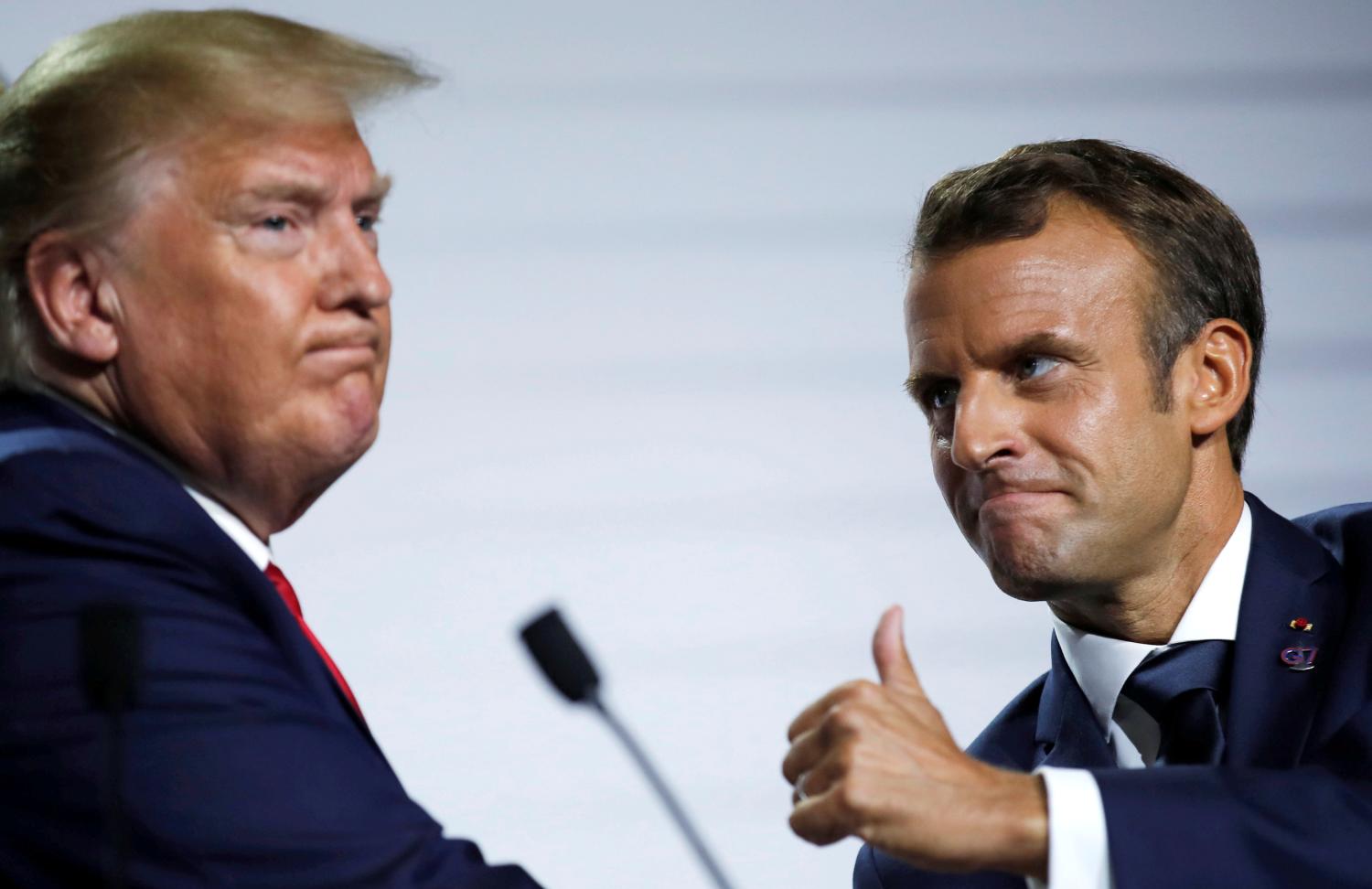 French President Emmanuel Macron and U.S. President Donald Trump react during a news conference at the end of the G7 summit in Biarritz, France, August 26, 2019. REUTERS/Carlos Barria     TPX IMAGES OF THE DAY - RC19EBF26190