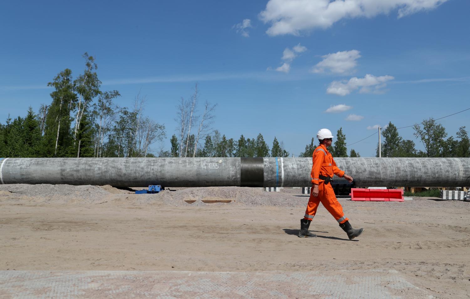 A worker walks near a pipe at the construction site of the Nord Stream 2 gas pipeline, near the town of Kingisepp, Leningrad region, Russia June 5, 2019. REUTERS/Anton Vaganov - RC1AFBC68700