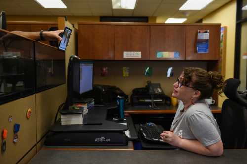 Lauren Hoffmann, 29, a college program manager, interacts with a colleague at work in San Antonio, Texas, U.S., February 15, 2019. Hoffmann's baby boy Micah is just a few weeks old and already she is back at work. She only had five and a half weeks of accrued paid time off from her job. "You're worried about this tiny little new life, you love it so fiercely," she said. "Having more time to feel like you're getting good at this ... I think that could only be a good thing." REUTERS/Callaghan O'Hare  SEARCH "O'HARE PARENTAL" FOR THIS STORY. SEARCH "WIDER IMAGE" FOR ALL STORIES. - RC1B59146620