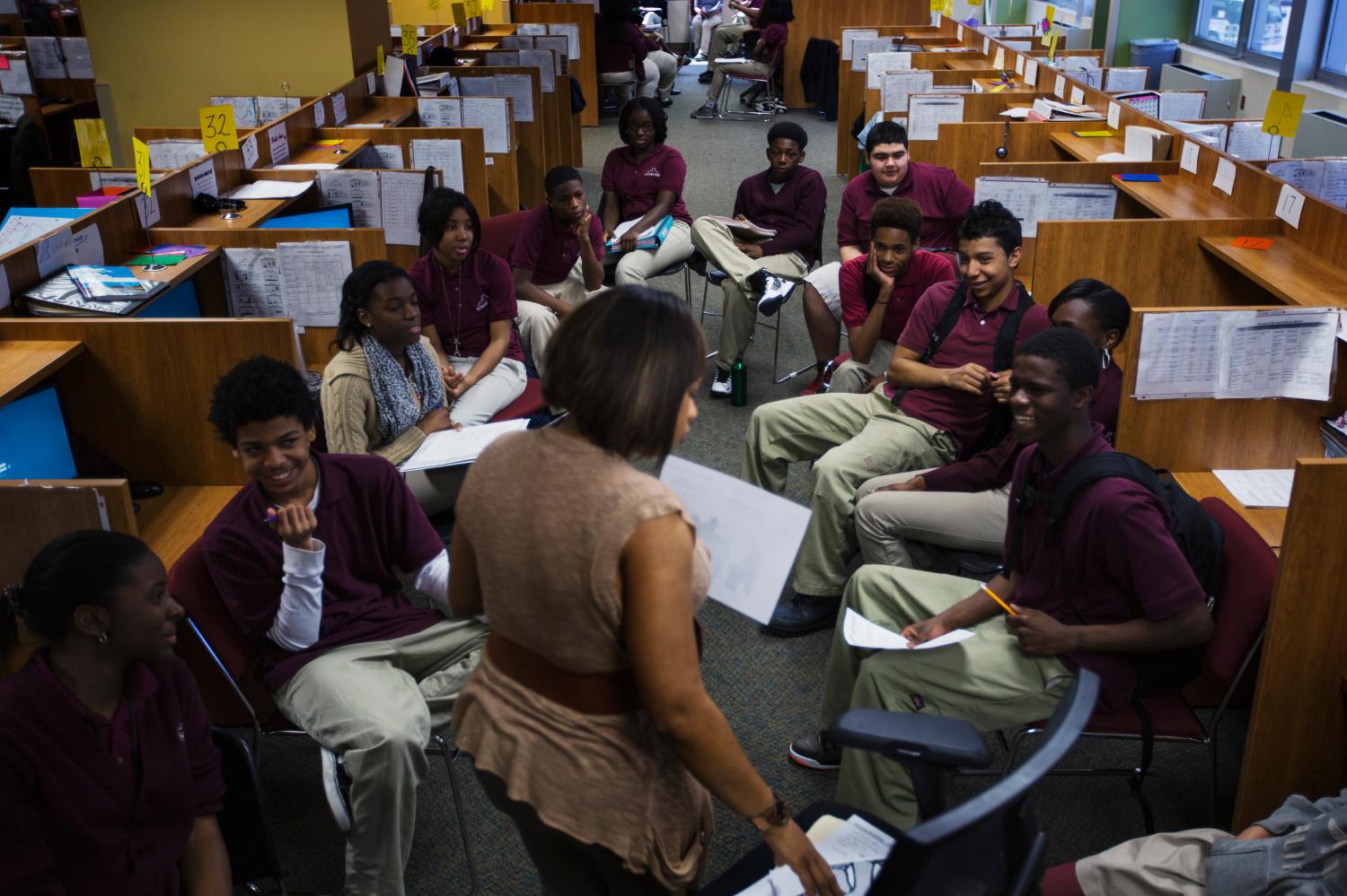 Newark Prep Charter School students listen to academic coach, Robbie Garland, while taking part in an advisory session at the school in Newark, New Jersey April 16, 2013. REUTERS/Lucas Jackson (UNITED STATES - Tags: EDUCATION) - TM4E94Q0XVB01