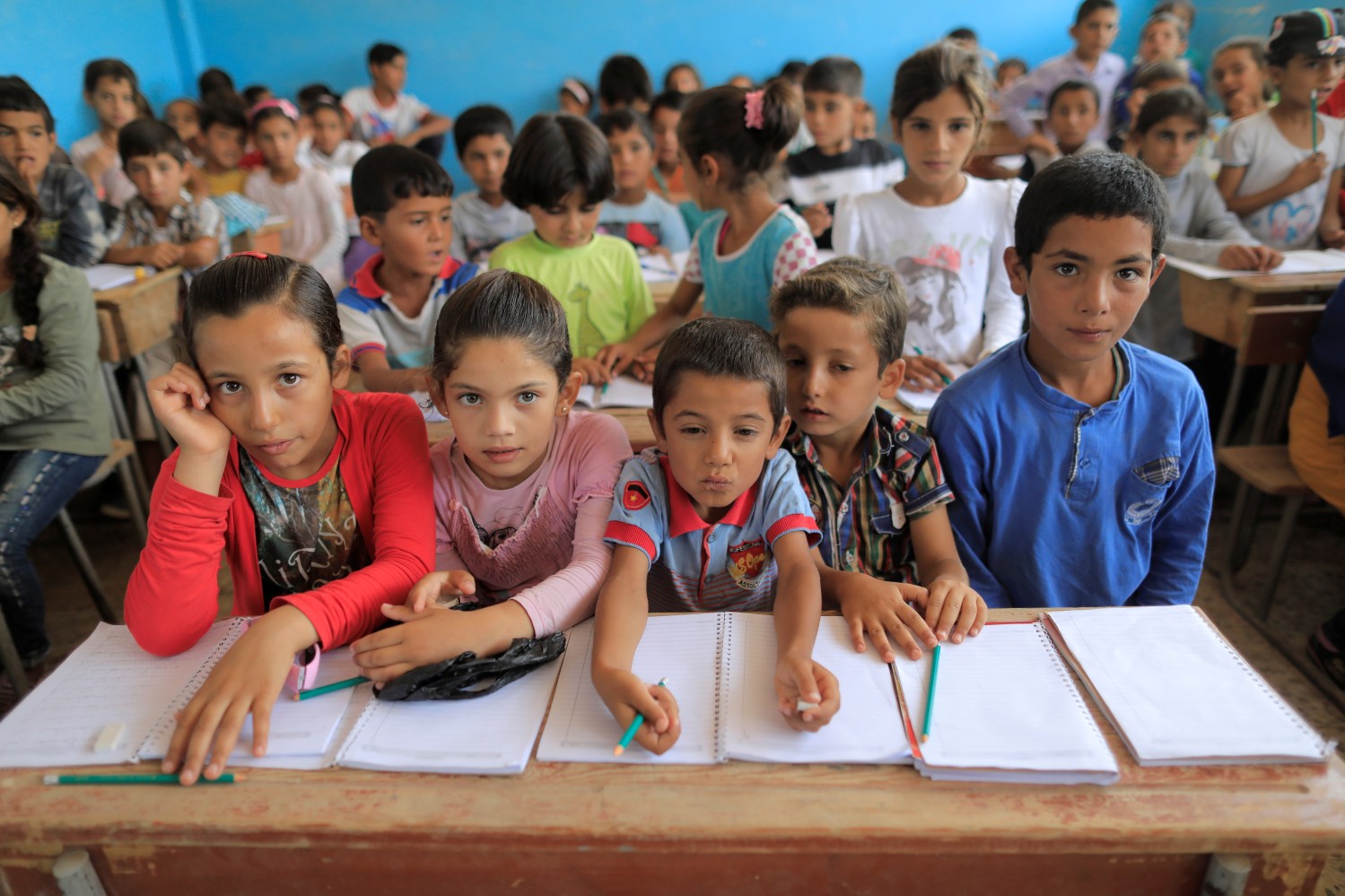 Children attend their first class immediately after they got registered at the school in Hazema North Raqqa, Syria August 21, 2017. Picture taken August 21, 2017. REUTERS/Zohra Bensemra - RC14C09853B0